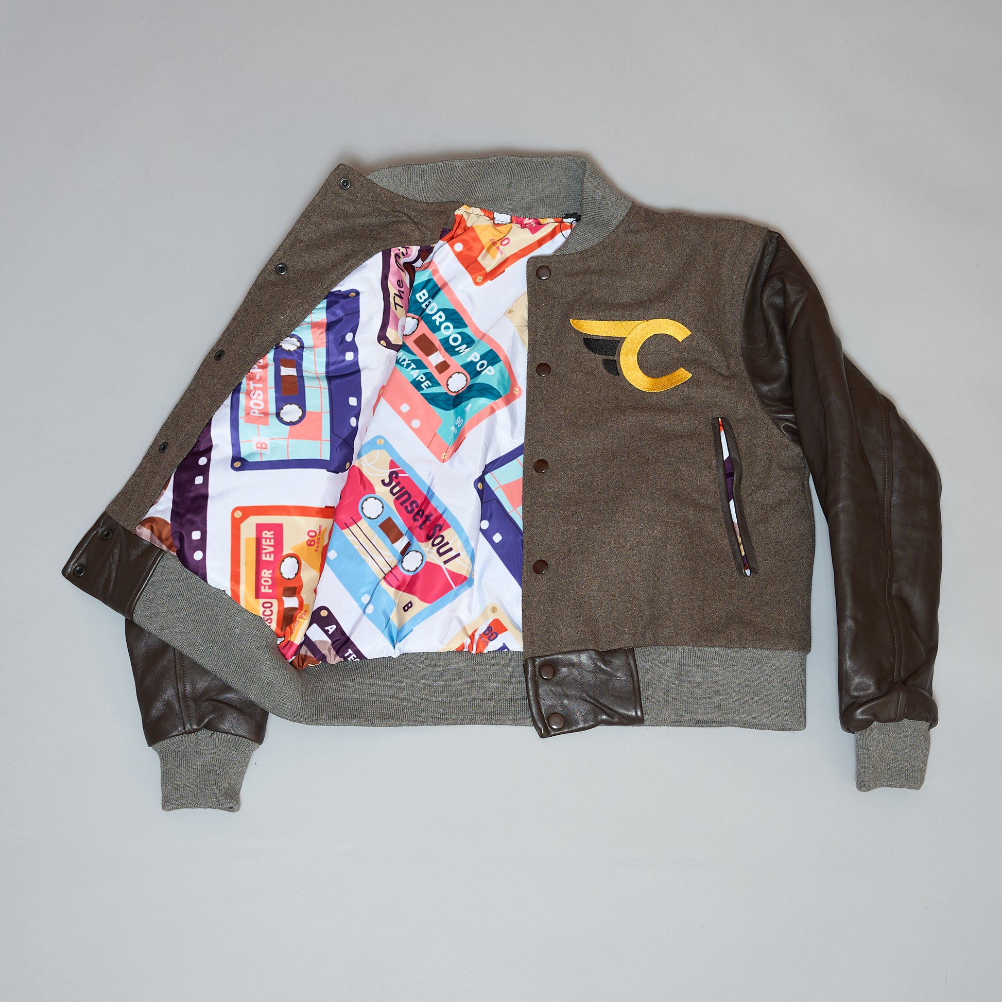 Brown and gray jacket with colorful interior lining on a light gray background