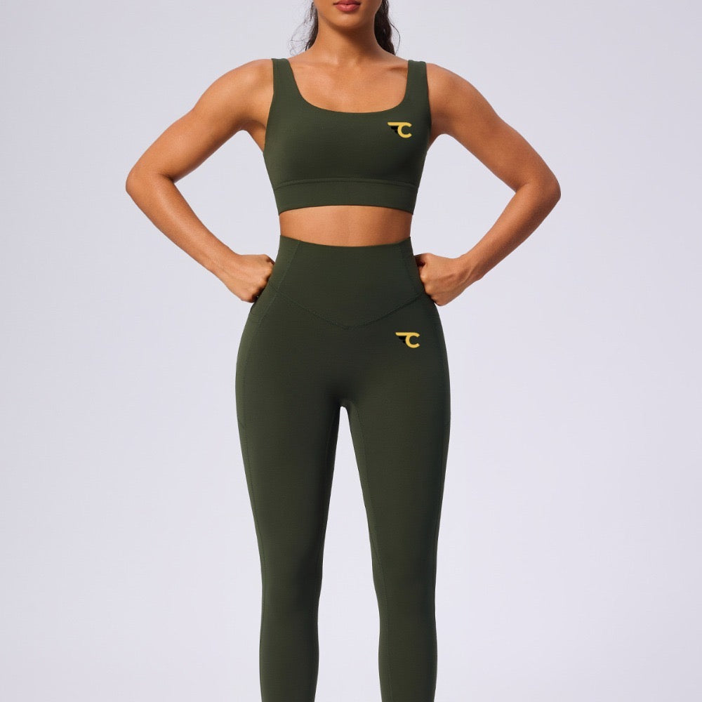 Person wearing green athletic outfit with brand logo on a light gray background